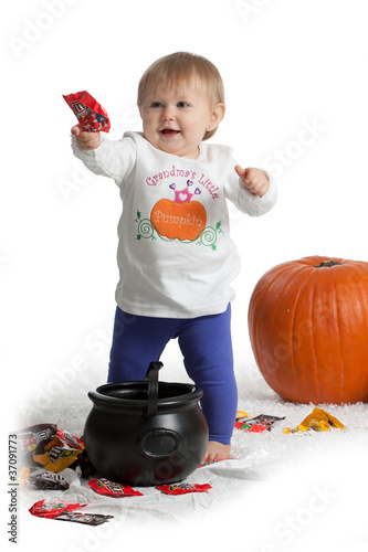 Girl holding candy with pumpkins