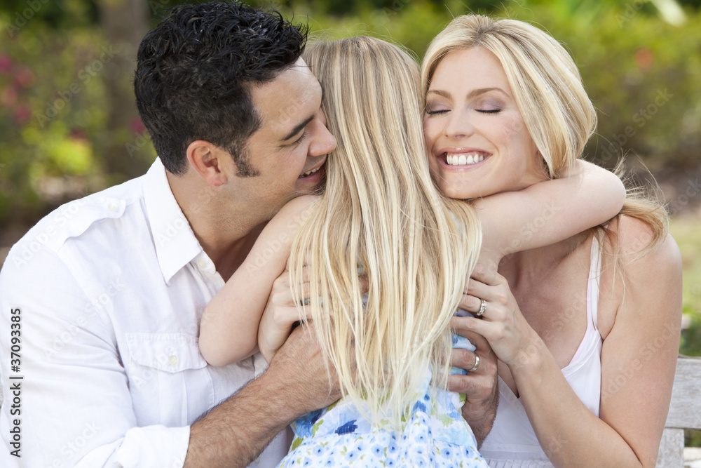Girl Child Hugging Happy Parents In Park or Garden Girl Child Hugging Happy Parents In Park or Garden