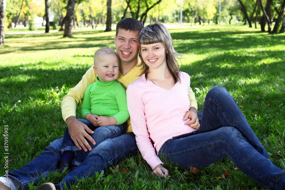 Young family with a child in summer park Young family with a child in summer park