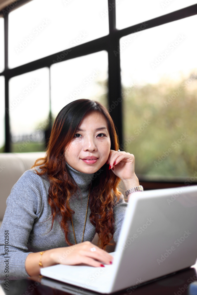 Smiling asian business woman with laptop Smiling asian business woman with laptop