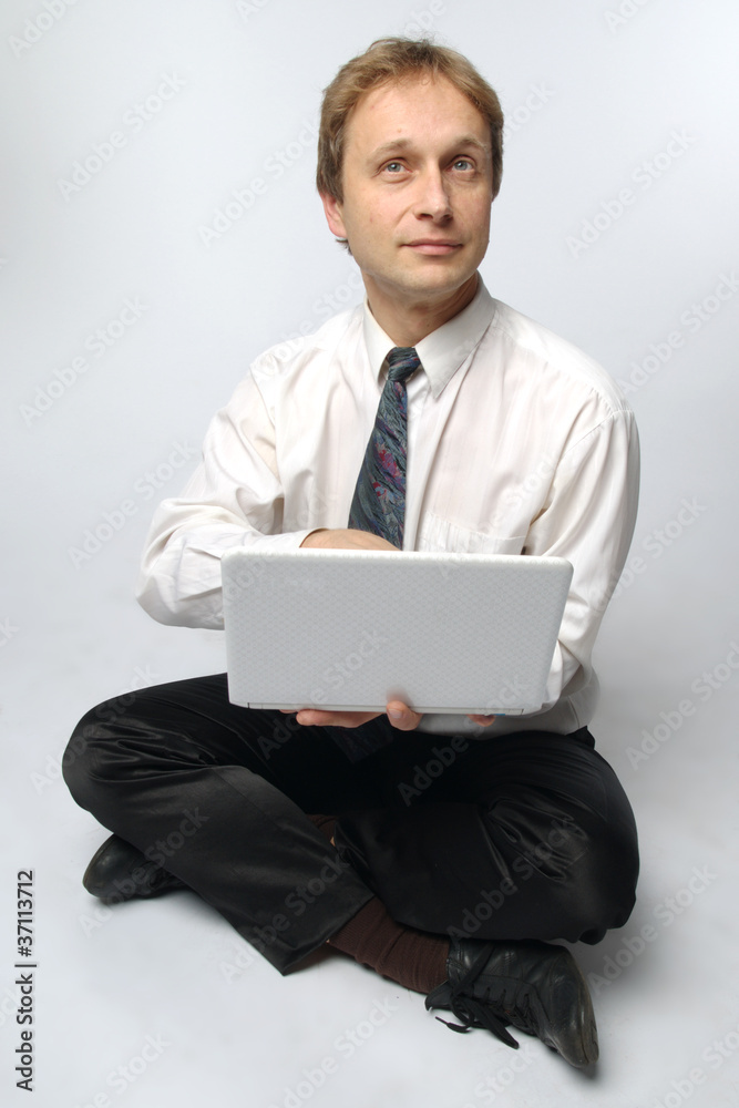 Young businessman yoga before an open notebook Young businessman yoga before an open notebook