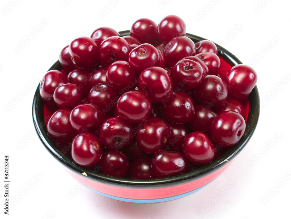 Bowl with ripe cherries. Isolated on a white background. Bowl with ripe cherries. Isolated on a white background.