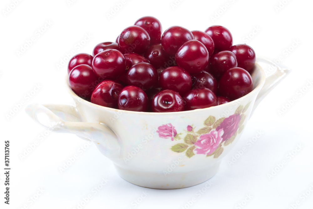 Bowl with ripe cherries. Isolated on a white background. Bowl with ripe cherries. Isolated on a white background.