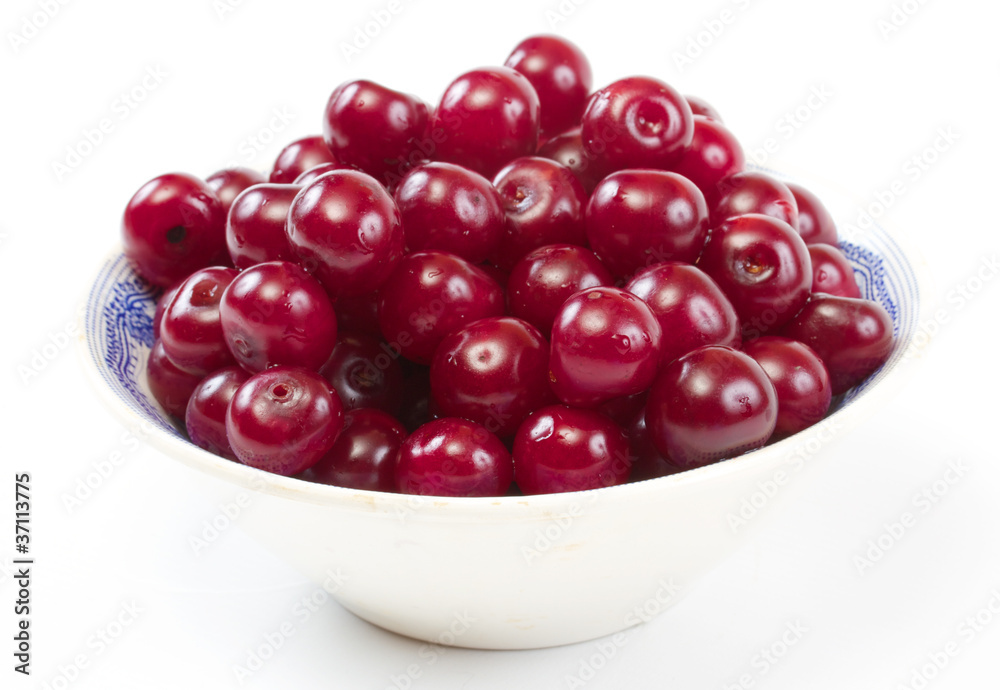 Bowl with ripe cherries. Isolated on a white background. Bowl with ripe cherries. Isolated on a white background.