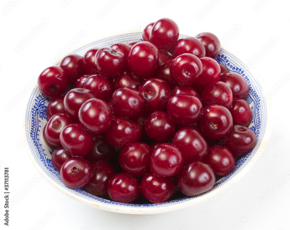 Bowl with ripe cherries. Isolated on a white background. Bowl with ripe cherries. Isolated on a white background.