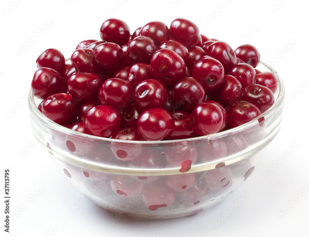 Bowl with ripe cherries. Isolated on a white background.