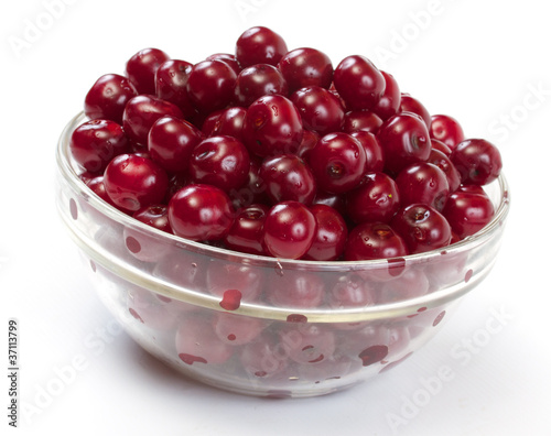 Bowl with ripe cherries. Isolated on a white background.