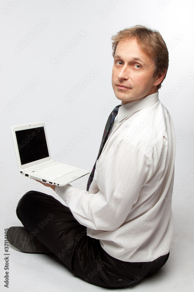 Portrait of middle-aged man with a white laptop computer Portrait of middle-aged man with a white laptop computer