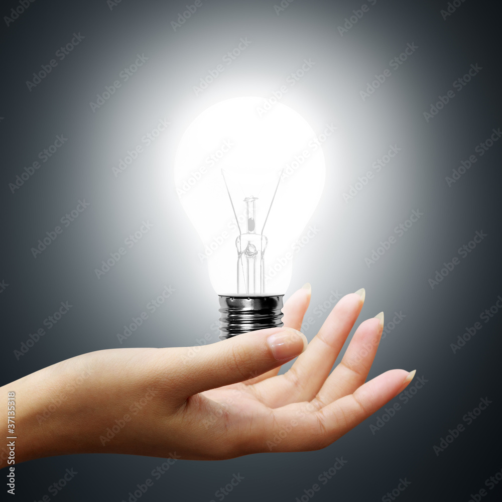 light bulb on business hands on gray background light bulb on business hands on gray background