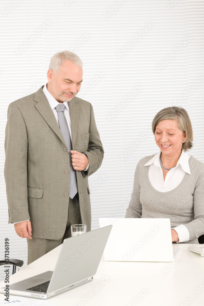 Senior happy businesspeople working on computer Senior happy businesspeople working on computer