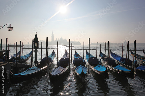 Gondolas in foggy morning in Venice, Italy