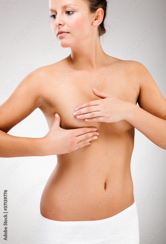 Woman examining her breast Woman examining her breast