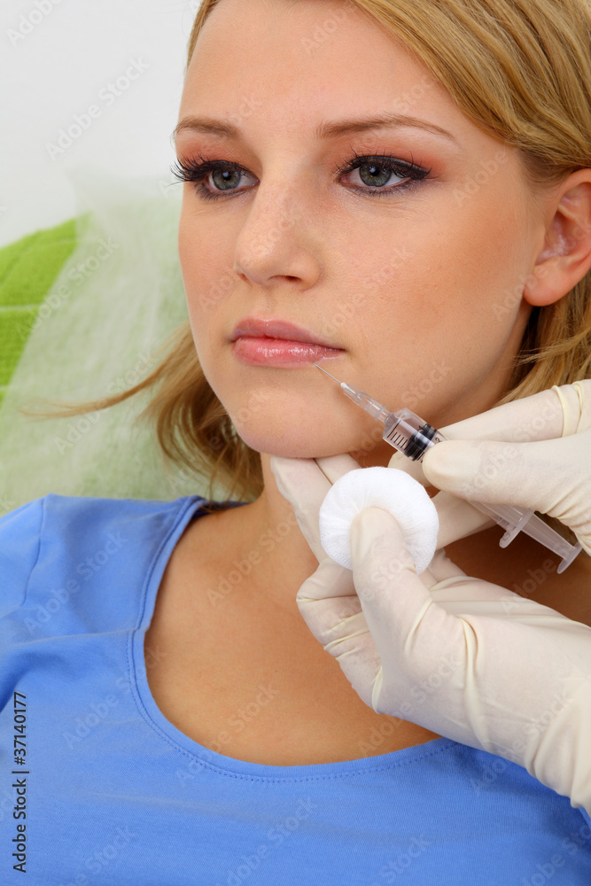 Attractive young woman receiving botox injection