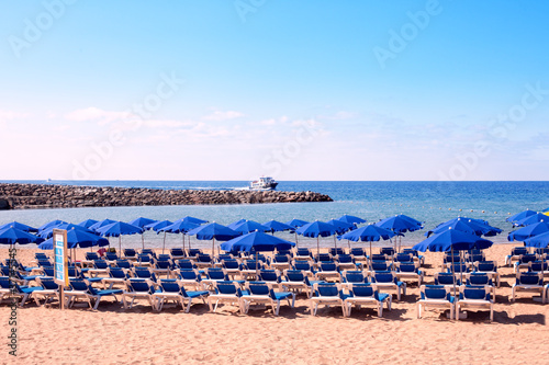 Sunbeds and umbrellas on a beach in a morning