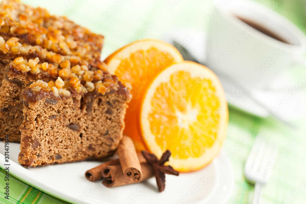Gingerbread with orange and cup of coffee or tea.