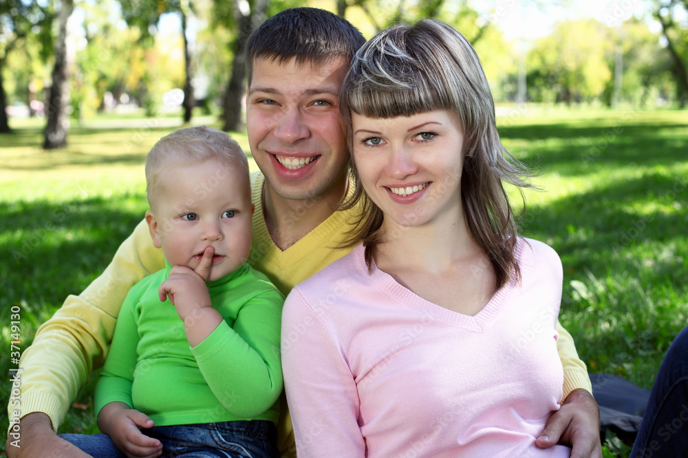 Young family with a child in summer park Young family with a child in summer park