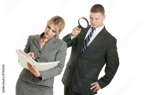 Fotografie Business man spying on business woman with magnifying glass