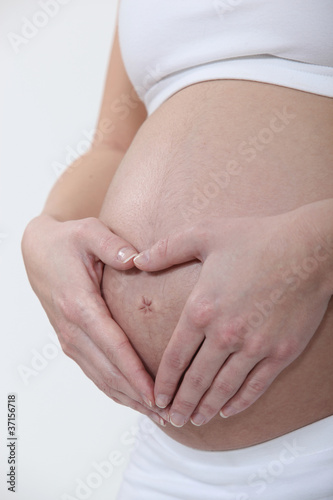 Woman hugging her pregnant belly