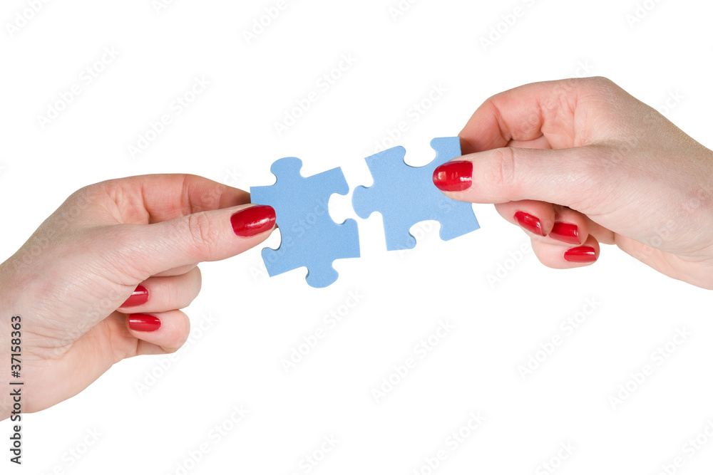 hands with different pieces of puzzle