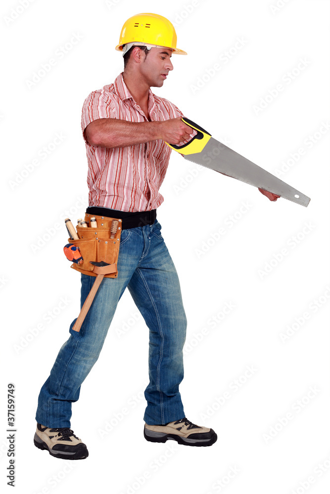 A male carpenter with a handsaw. A male carpenter with a handsaw.