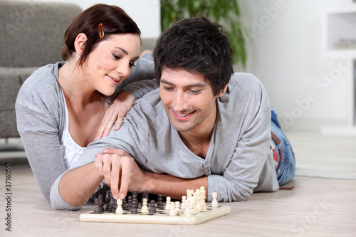 happy couple playing chess