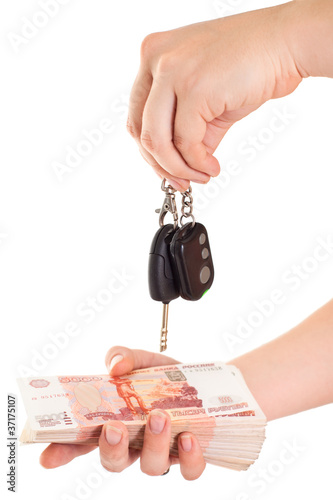 Car key and cash money in hands isolated on white background photo