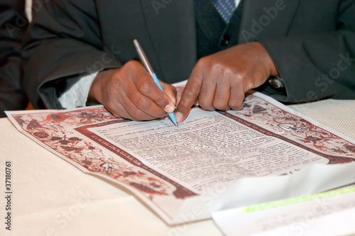Jewish wedding, signing prenuptial agreement  ketubah
