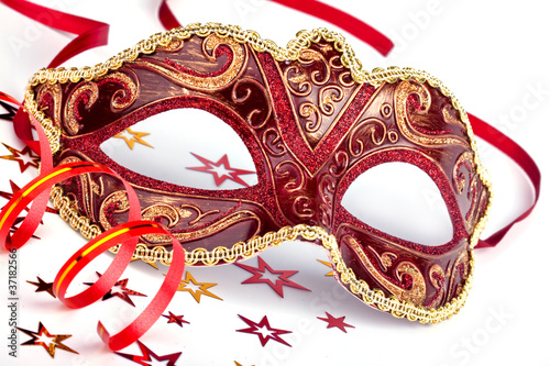Red carnival mask with confetti and streamer