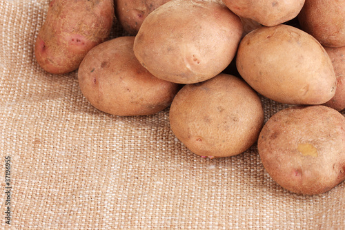 fresh potatoes on burlap closeup