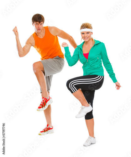 Healthy girl and guy in sportswear doing aerobics