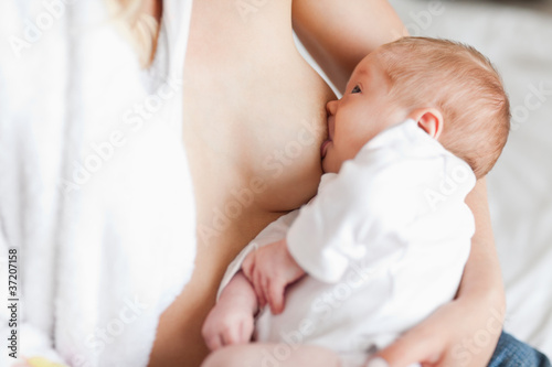 Fotografie Mother suckling her newborn
