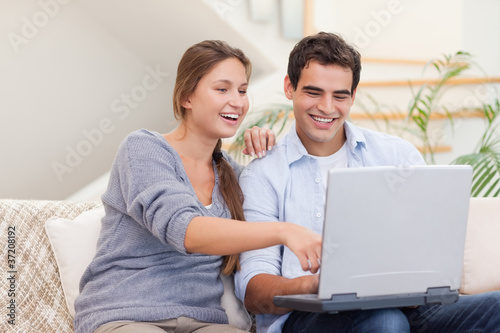 Happy couple using a laptop