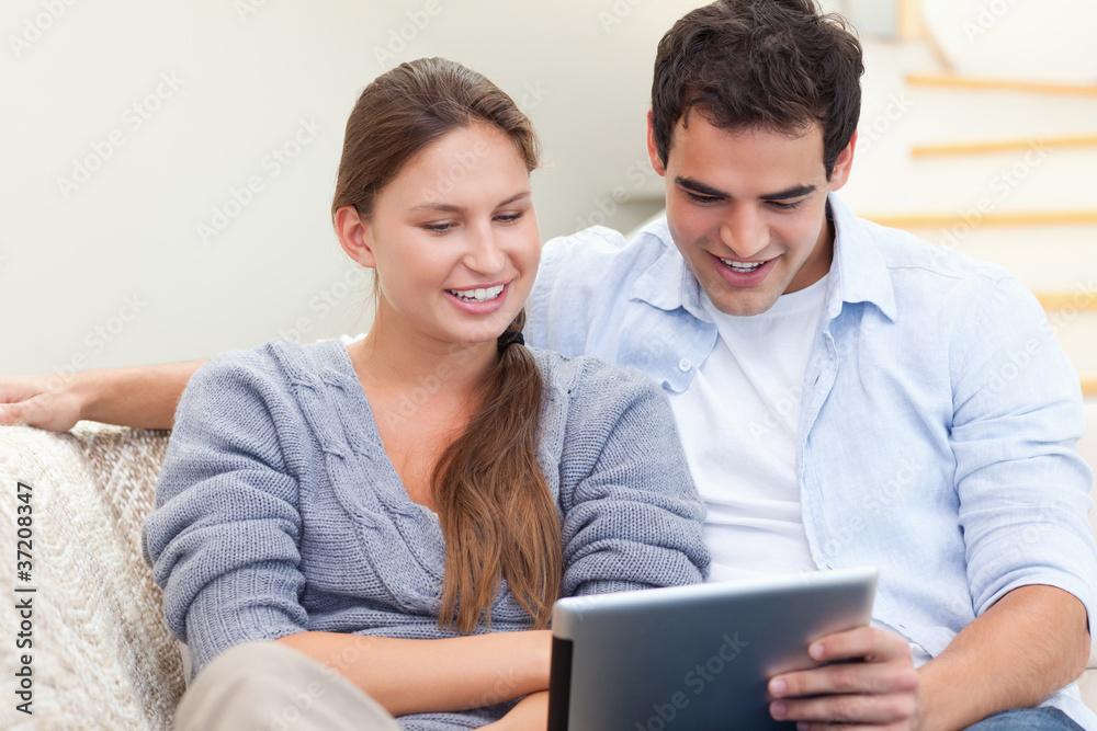 Young couple using a tablet computer Young couple using a tablet computer