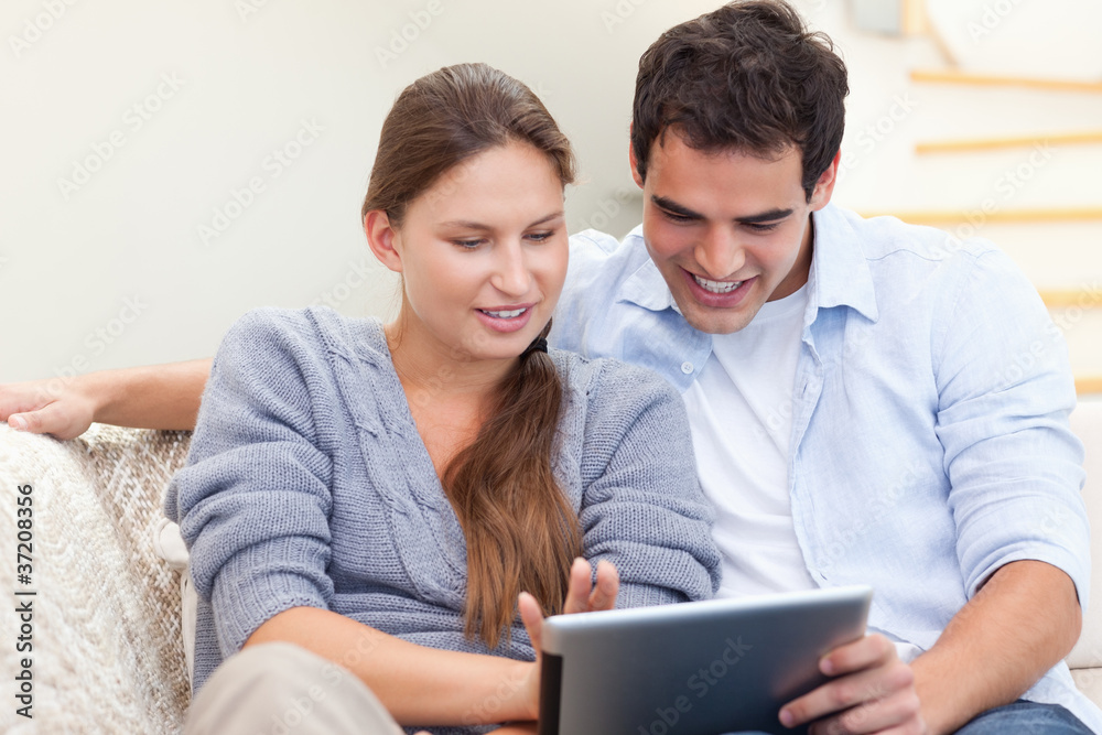Happy couple using a tablet computer Happy couple using a tablet computer