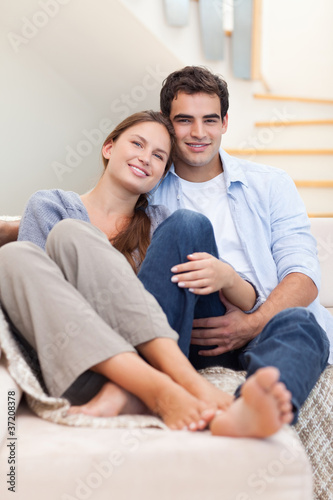 Portrait of a couple lying on a sofa