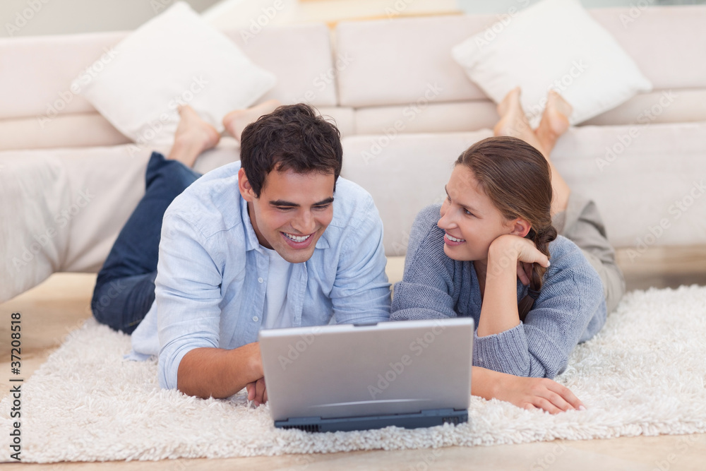 Smiling couple surfing on the internet Smiling couple surfing on the internet
