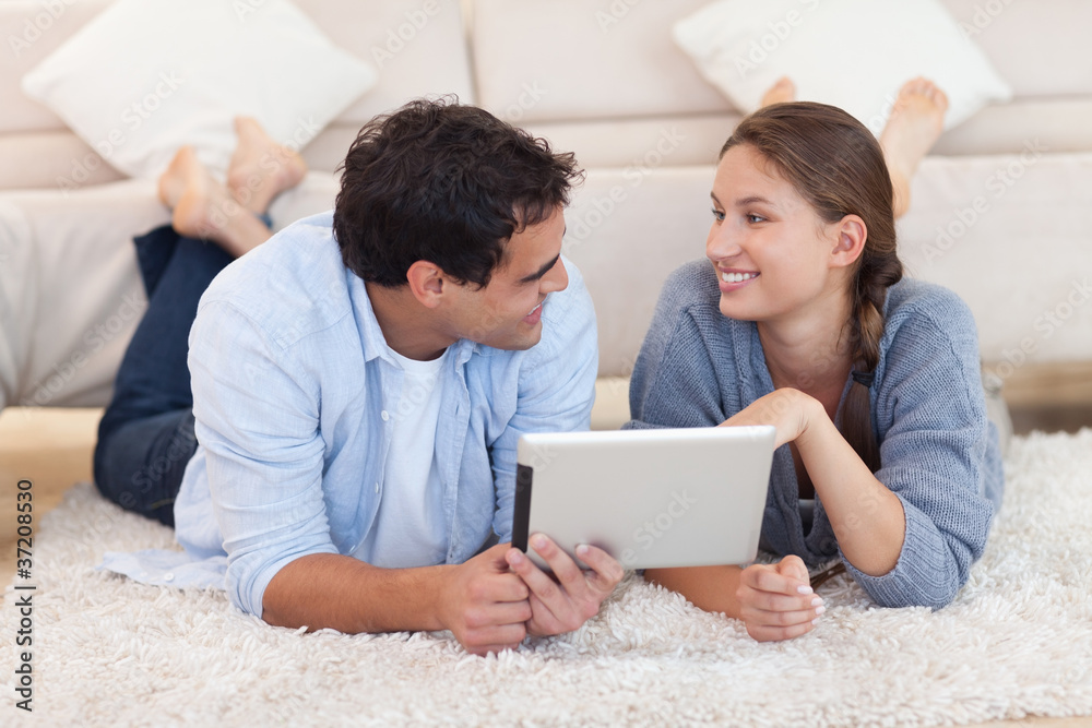 Cute couple using a tablet computer Cute couple using a tablet computer