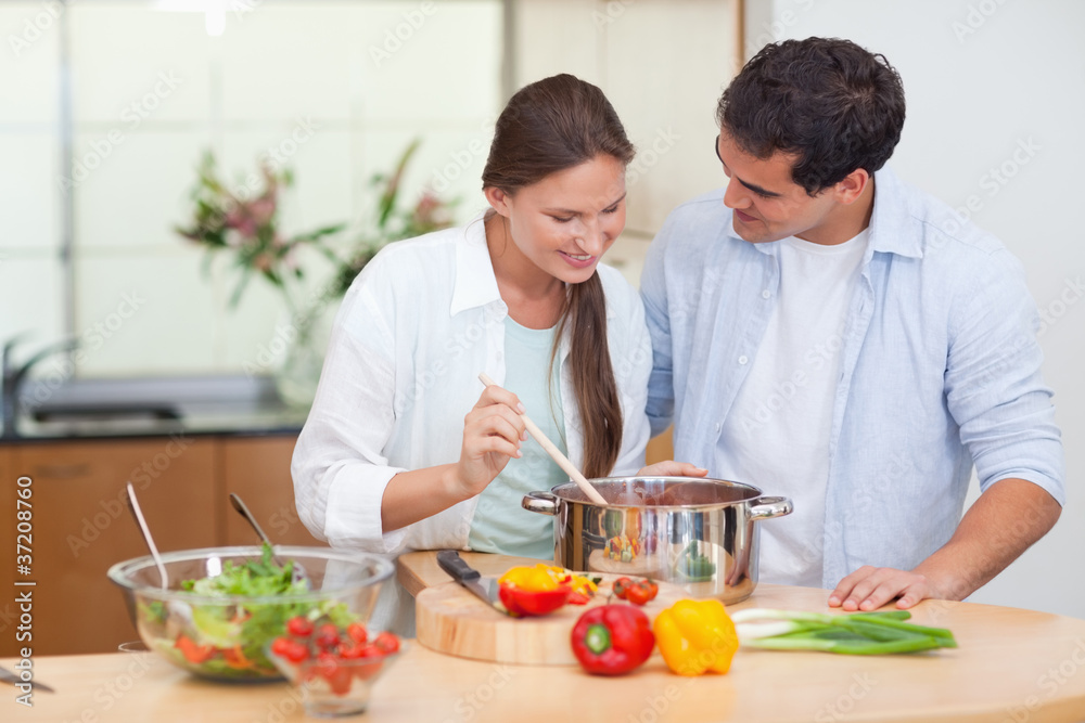 Couple preparing a sauce Couple preparing a sauce