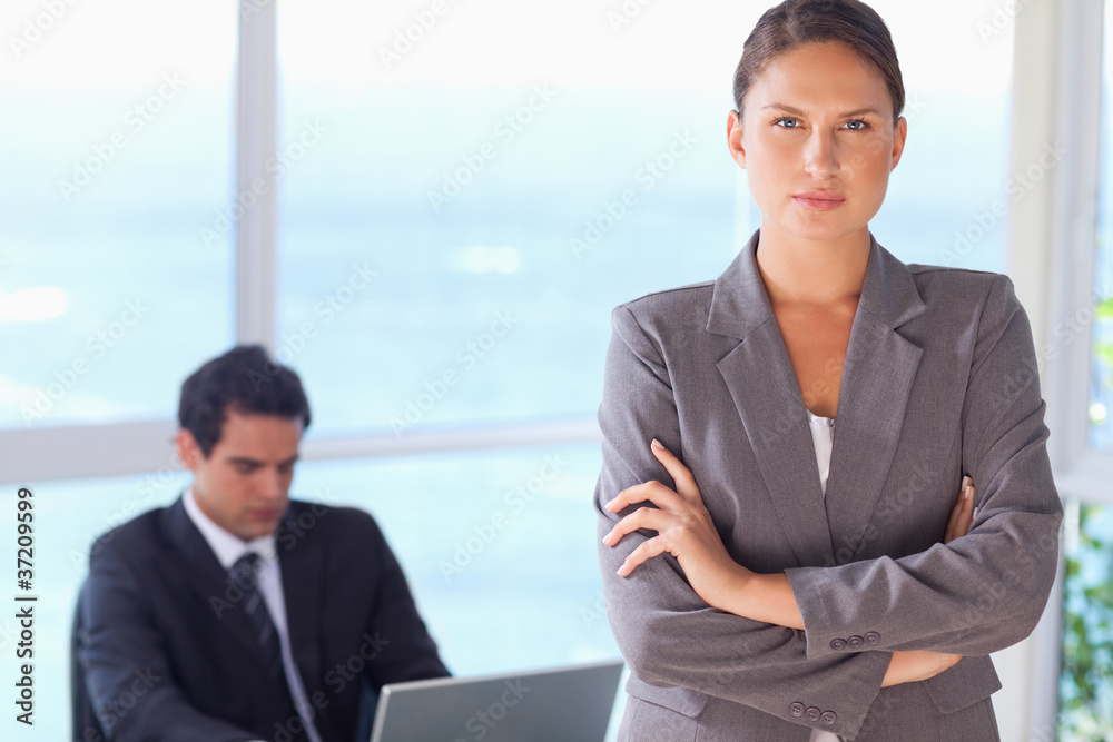 Serious looking tradeswoman with arms folded Serious looking tradeswoman with arms folded