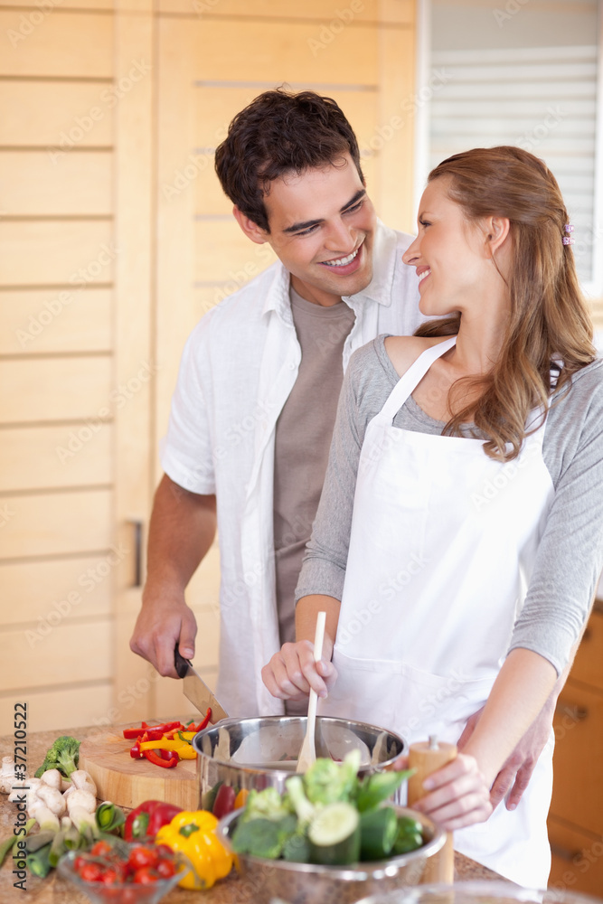 Man helping his girlfriend cooking Man helping his girlfriend cooking