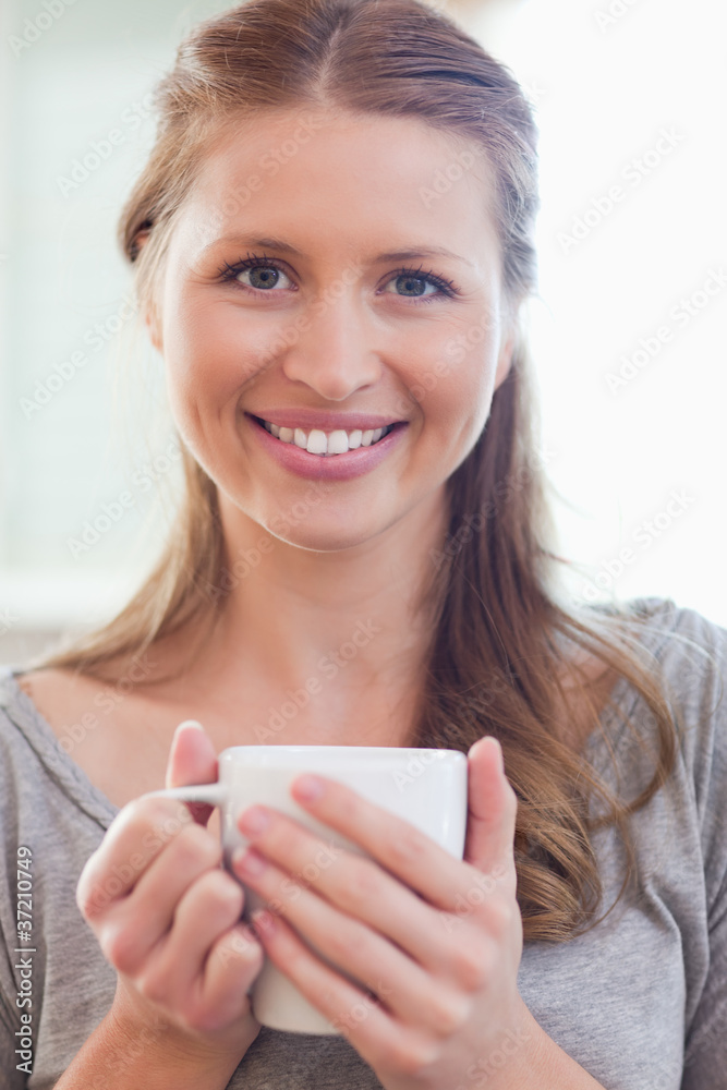 Close up of smiling woman with a cup of coffee Close up of smiling woman with a cup of coffee