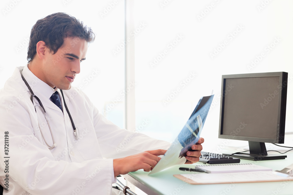 Doctor analyzing an x-ray Doctor analyzing an x-ray