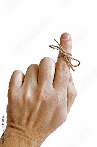 String tied on finger as reminder isolated on white background photo