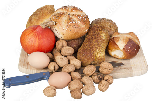 gem, nuts, eggs and a pumpkin on a wooden board