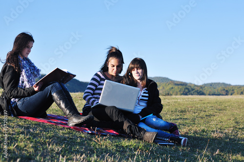 young girl work on laptop outdoor