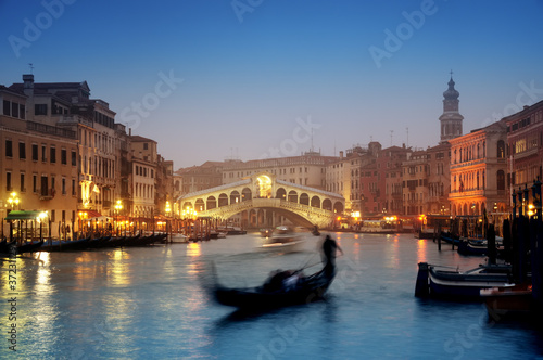 Rialto Bridge and gondolas at a foggy autumn evening in Venice. © fazon