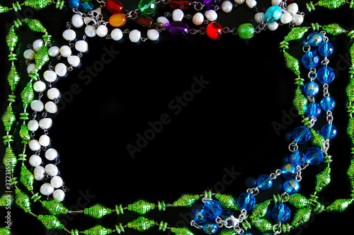 assorted bead necklaces forming a border on black photo