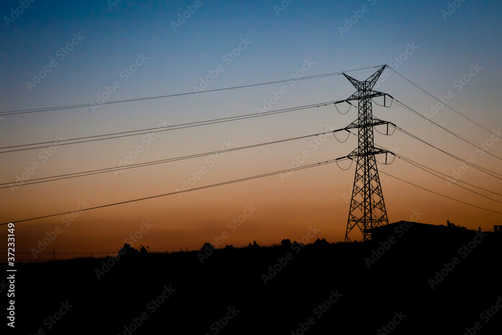Silhouette of an Electricity pylon at sunset