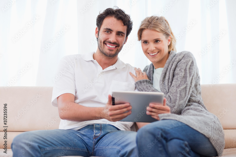 Smiling couple using a tablet computer Smiling couple using a tablet computer