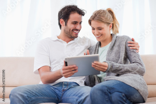 Happy couple using a tablet computer